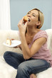 Young woman eating cake