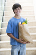 A young boy with a bag of shopping