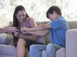 A brother and sister fighting over the remote control