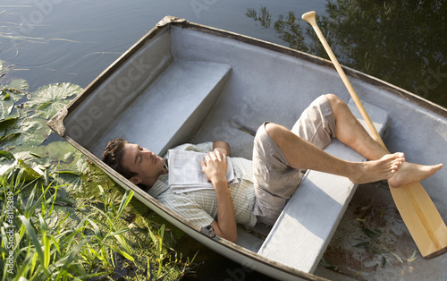 Photo: Young man asleep in a boat Young man asleep in a boat