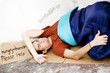 Homeless young man laying in the street
