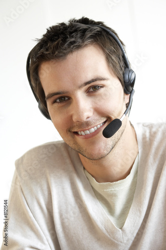 Photo: Young man wearing a headset Young man wearing a headset