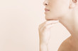 Detail of young woman's face, hand held under her chin