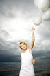 A young boy with a bunch of balloons