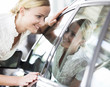 A young woman admiring a new car