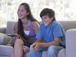 A brother and sister watching TV