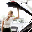 A young woman admiring a new car