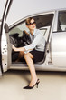 A businesswoman getting out of a car