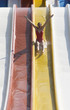 A woman coming down a slide in a waterpark