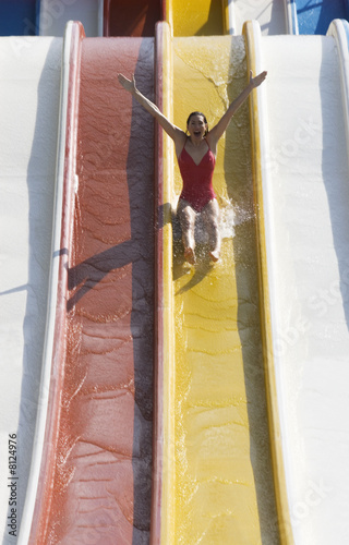 Photo: A woman coming down a slide in a waterpark A woman coming down a slide in a waterpark