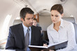 A businessman talking to his PA on a plane