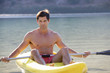 A man canoeing on a lake