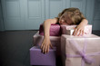 Young girl asleep and laying on her with birthday presents