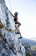 A climber climbing a rock face
