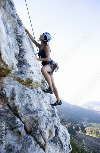 Photo: A climber climbing a rock face A climber climbing a rock face
