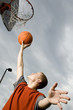 A teenage boy playing basketball