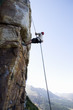 A climber climbing a rock face