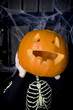 Photo: Child in a skeleton costume at a Hallowe'en party, holding a pumpkin with a carved face Child in a skeleton costume at a Hallowe'en party, holding a pumpkin with a carved face