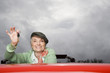 Portrait of a senior woman in a convertible car
