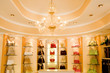 Selection of designer handbags on shelf display in glamorous boutique