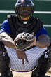 Photo: Baseball catcher crouching on pitch, making secret signal with fingers, front view, portrait Baseball catcher crouching on pitch, making secret signal with fingers, front view, portrait