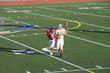 Photo: American football player chasing opposing receiver about to catch ball during competitive game American football player chasing opposing receiver about to catch ball during competitive game