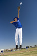 Photo: Baseball player, in blue uniform, jumping up to catch ball in protective glove during competitive game (surface level, tilt) Baseball player, in blue uniform, jumping up to catch ball in protective glove during competitive game (surface level, tilt)