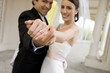 Photo: Bride and groom embracing in colonnade, focus on bride’s wedding ring in foreground, smiling, portrait (tilt) Bride and groom embracing in colonnade, focus on bride’s wedding ring in foreground, smiling, portrait (tilt)