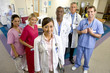 Photo: Hospital staff standing in ward, smiling, portrait, young female doctor in foreground Hospital staff standing in ward, smiling, portrait, young female doctor in foreground