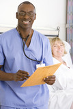 Photo: Male nurse holding folder by mature female patient lying in hospital bed, smiling, portrait Male nurse holding folder by mature female patient lying in hospital bed, smiling, portrait