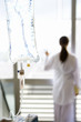 Photo: IV bag, young female patient looking out window in background (differential focus) IV bag, young female patient looking out window in background (differential focus)