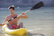 A man canoeing on a lake