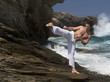 A man practicing Tai Chi by the sea