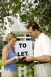 Woman consulting letting agent about property to let