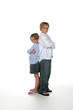 brother and sister standing back to back with arms crossed