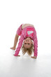 cute girl in a gymnastics bridge position 