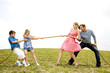 family of four playing tug of war