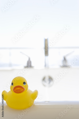 Photo: Rubber duck on side of bath Rubber duck on side of bath