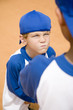 Photo: boy glaring at another boy on baseball pitch boy glaring at another boy on baseball pitch