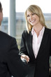 Businesswoman shaking hands with male client or colleague