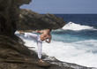 A man practicing Tai Chi by the sea