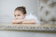 Portrait of a young girl with a feather boa in dressing up clothes