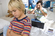 Father reprimanding son (6-8) in bedroom, close-up of boy