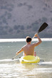A man canoeing on a lake