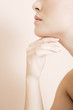 Detail of young woman's face, hand held under her chin