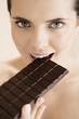 Woman eating a bar of chocolate