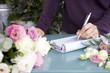 Woman florist taking an order over the telephone
