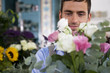 Male florist amongst the flowers in his shop