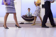 Photo: Businessman meditating in chair in office foyer, colleagues walking past, low section (blurred motion) Businessman meditating in chair in office foyer, colleagues walking past, low section (blurred motion)