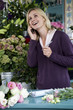 Woman florist taking an order over the telephone